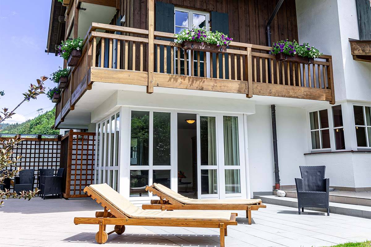 Große Terrasse mit zwei Liegestühlen vor dem Chalet, umgeben vom Bergpanorama in Grainau.