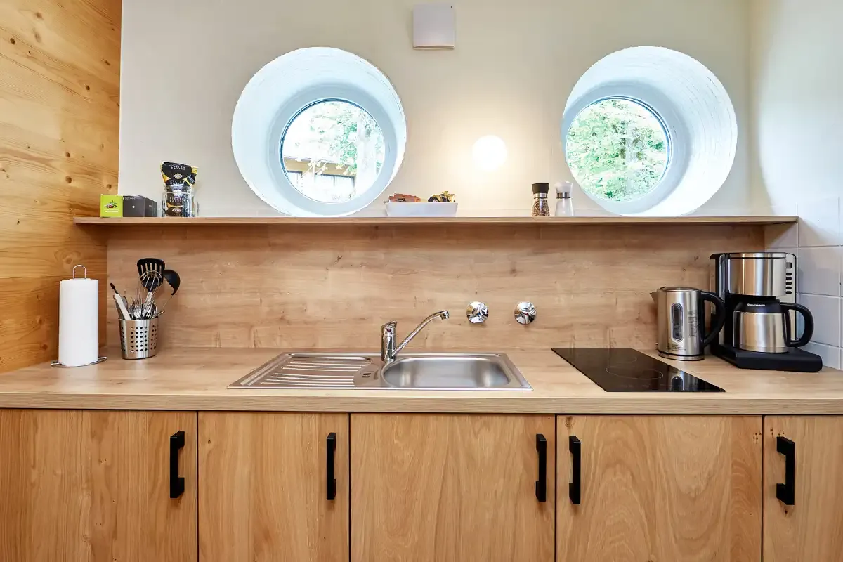 Moderne Küchenzeile aus Holz mit Spüle, Herd, Wasserkoche und Kaffemaschiene im Berghotel Hammersbach.